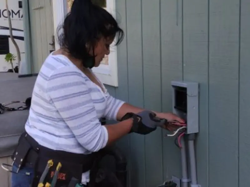 Licensed electrician wiring an exterior subpanel in Plano