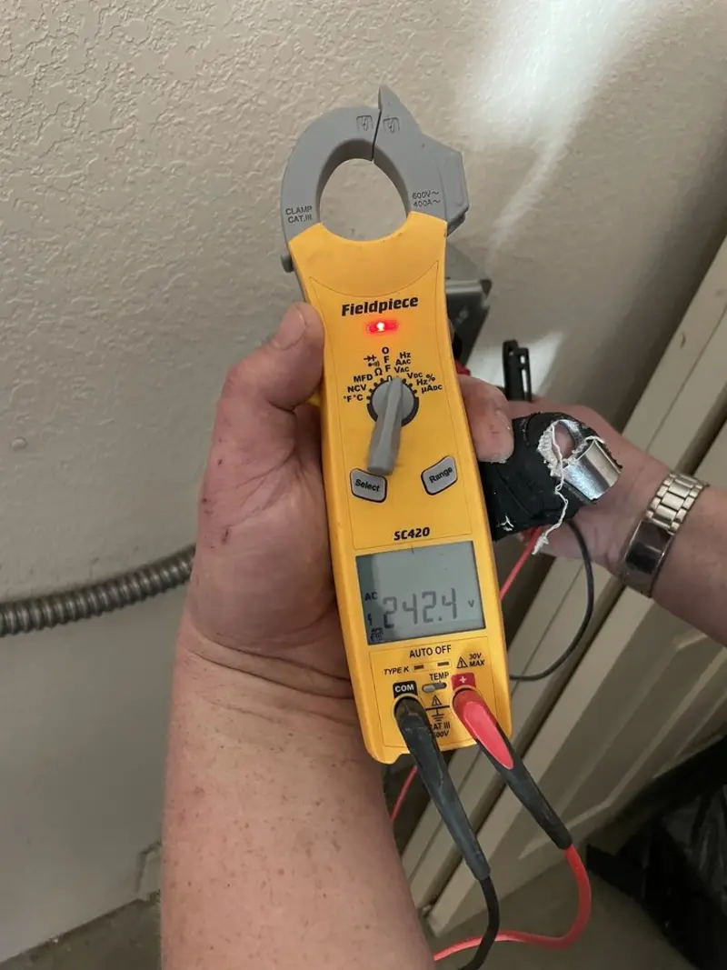 Voltage testing with clamp meter during Recessed Lighting Installation in Plano